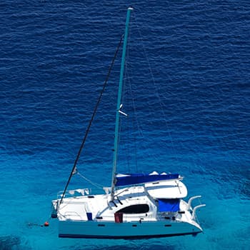 Catamaran sailing on a deep blue water