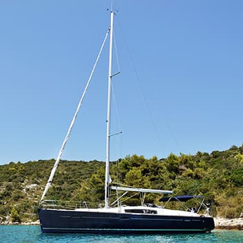 Sailboat on a water with hills in the background