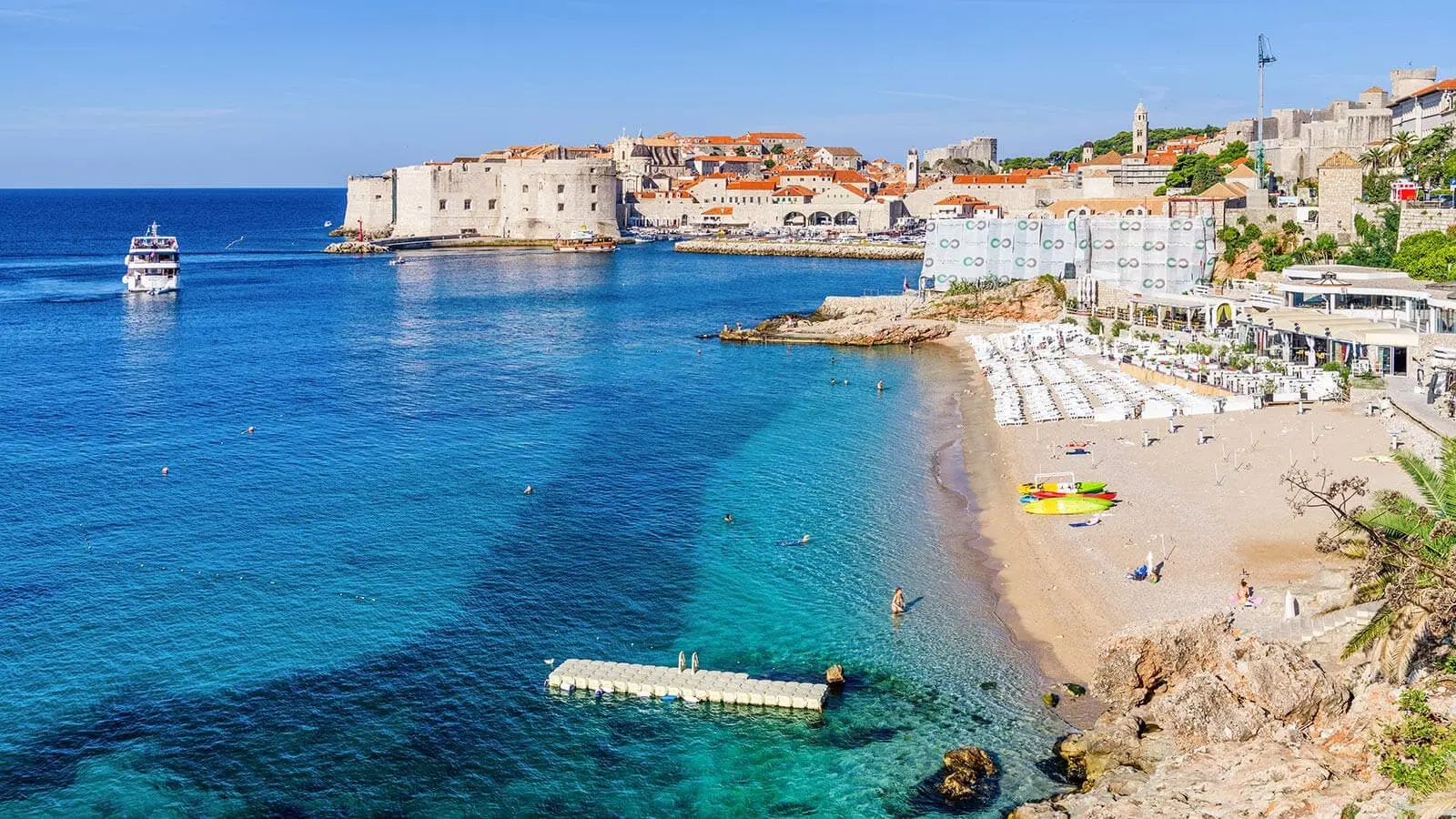 Banje beach with beach chairs and Dubrovnik in the background