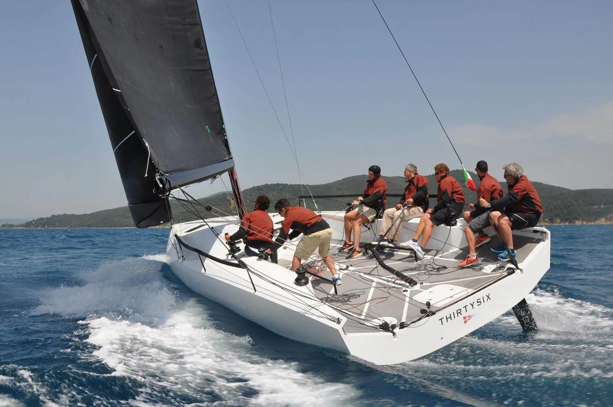 People sailing on a boat and handling ropes