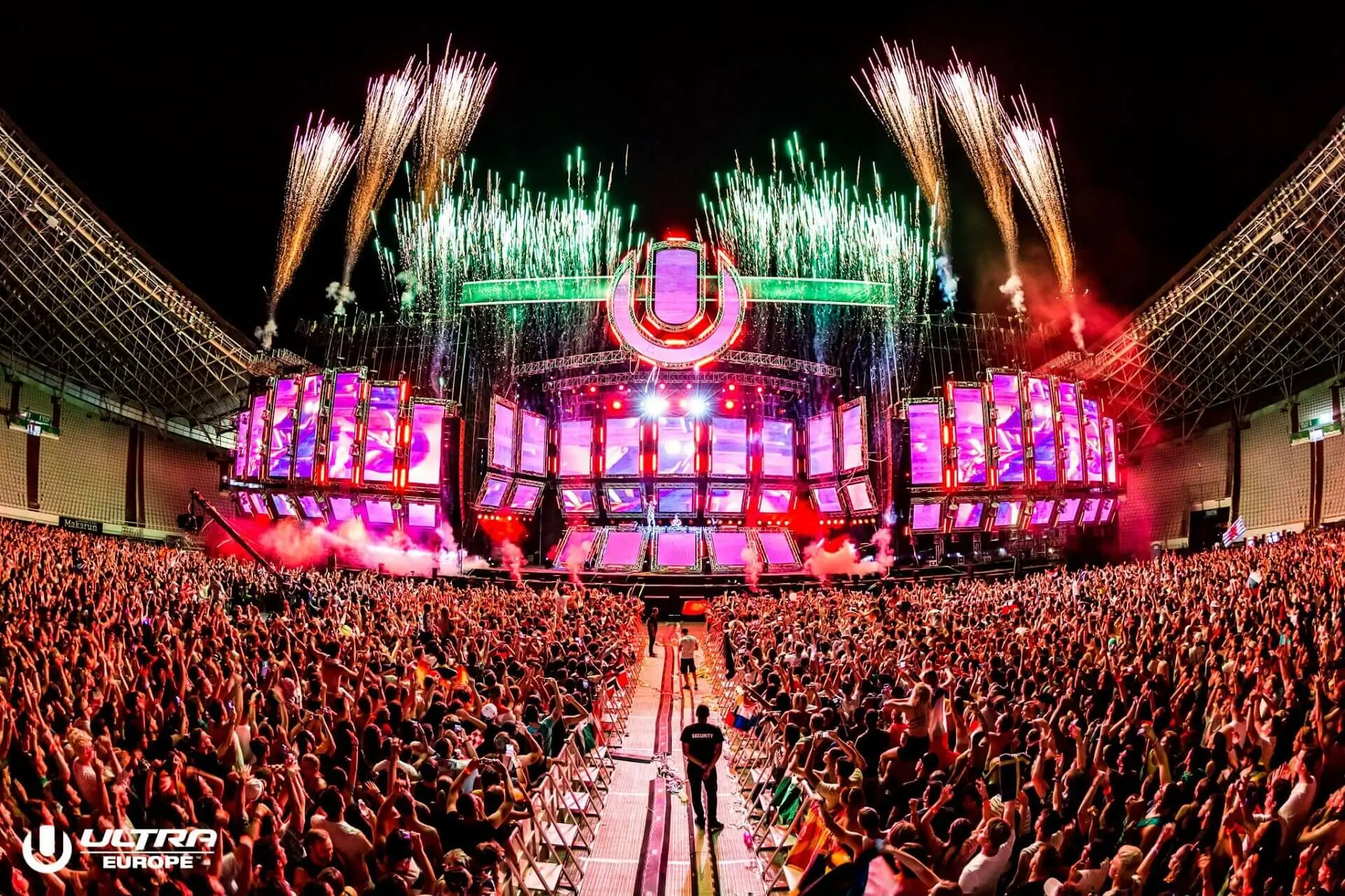 Ultra music festival with light show and many people partying