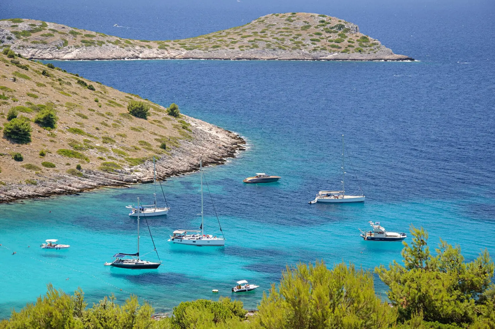 Kornati in Croatia with yachts sailing around in the emerald blue water