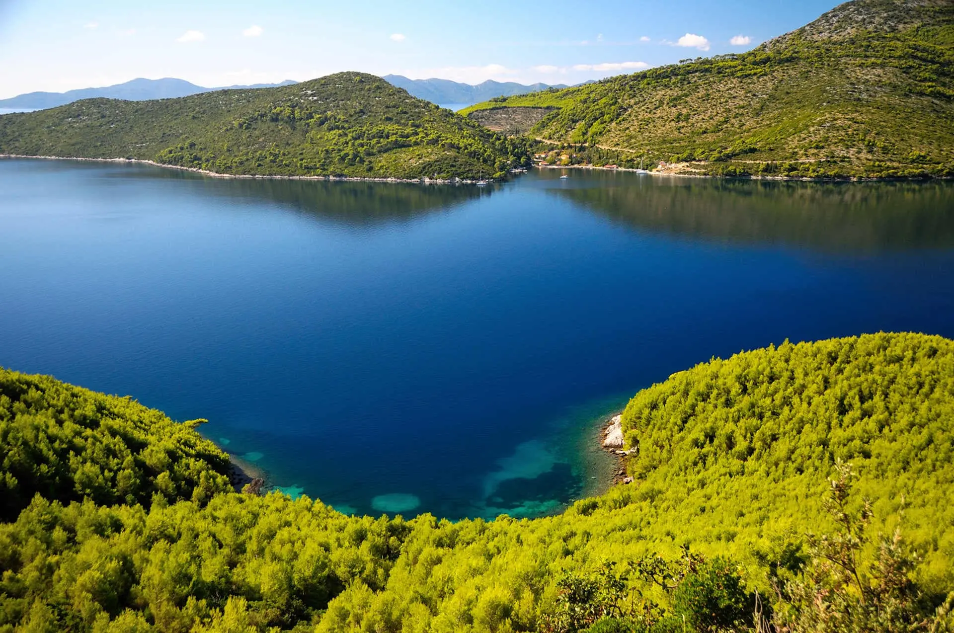 Kobas in Croatia with deep blue water and green forests